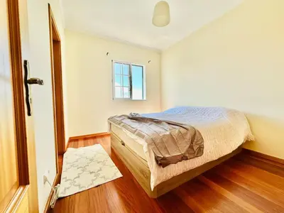 a bedroom with a bed and a window at Casa da Minha Luz in Santa Cruz