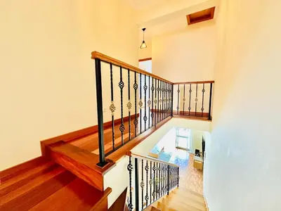 a staircase in a home with a wooden railing at Casa da Minha Luz in Santa Cruz