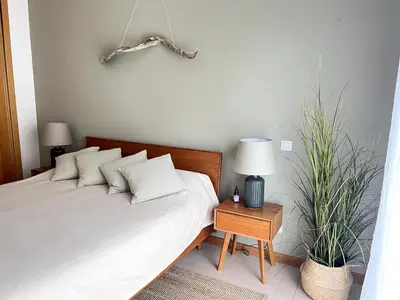 a bedroom with a bed and two potted plants at Casa Solaris Algarve in Burgau