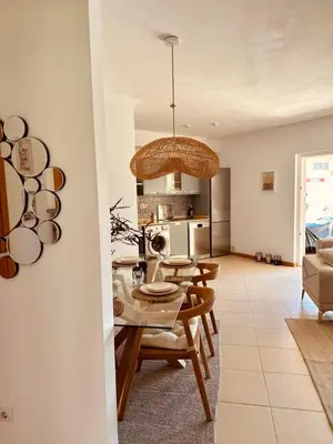 a dining room and kitchen with a table and chairs at Casa Solaris Algarve in Burgau