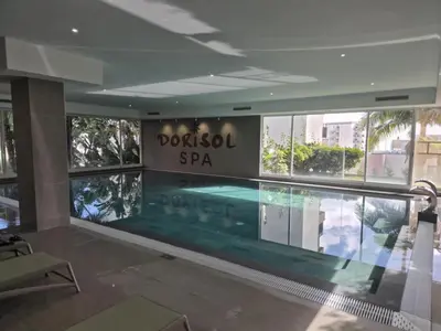 a swimming pool in a building with a sign that reads potosi spa at Hotel Bunganvilia in Funchal