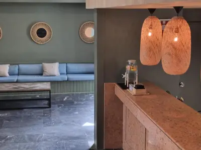 a kitchen with a counter and a blue couch at Hotel Bunganvilia in Funchal