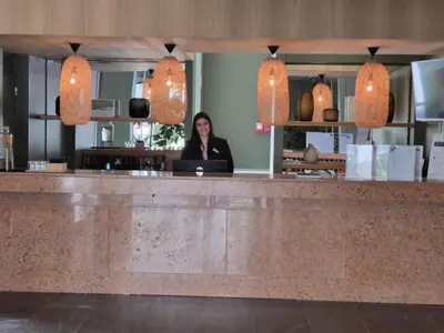 a woman behind the counter of a restaurant at Hotel Bunganvilia in Funchal