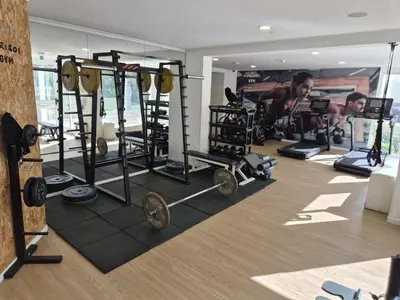 a gym with weights and other equipment in a room at Hotel Bunganvilia in Funchal