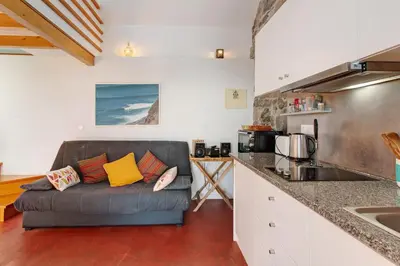 a living room with a couch in a kitchen at Romantic Retreat by Slice of Heaven in Jardim do Mar