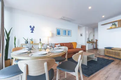 a living room with a table and chairs and a couch at Xavelha Clifftop by Atlantic Holiday in Câmara de Lobos