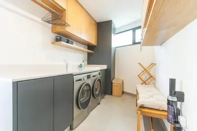 a laundry room with a washer and dryer at Xavelha Clifftop by Atlantic Holiday in Câmara de Lobos