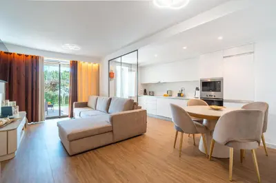 a living room with a couch and a table at Sunset Luxury Apartment by Amazing Madeira in Câmara de Lobos