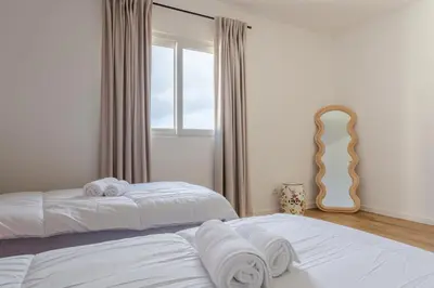 two beds in a bedroom with towels on them at Skyline Villa by Holiday Rental Madeira in Gaula