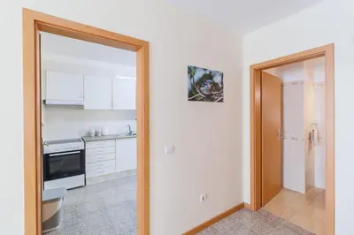 an open door to a kitchen with a sink and a stove at Santana Lens & Trail House in Santana