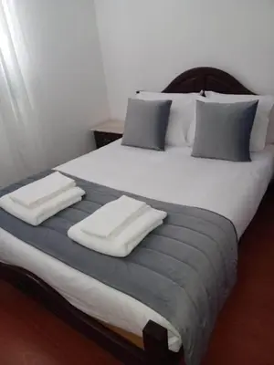 a large bed with two white towels on it at Villa Canhas in Canhas