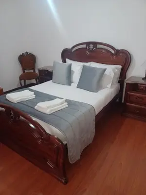 a bedroom with a bed with two towels on it at Villa Canhas in Canhas