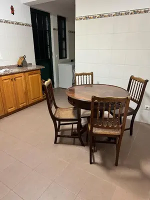 a kitchen with a wooden table and chairs at Villa Canhas in Canhas