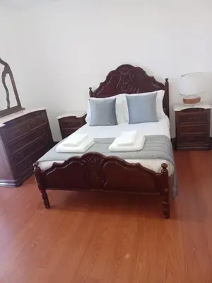 a bed in a bedroom with a wooden floor at Villa Canhas in Canhas