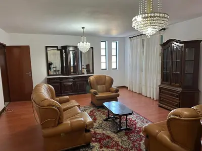 a living room with leather chairs and a table at Villa Canhas in Canhas