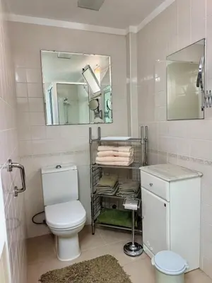 a bathroom with a toilet and a mirror at Apartamento Precioso in Arco da Calheta