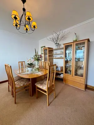 a dining room with a wooden table and chairs at Apartamento Precioso in Arco da Calheta