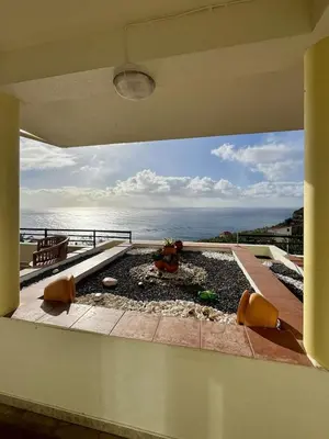 a view of the ocean from the balcony of a house at Apartamento Precioso in Arco da Calheta