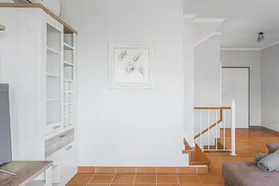 a living room with white walls and a staircase at New Casa Bondi by Your Madeira Rentals in Ponta do Sol