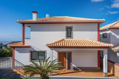 a white house with a red roof at New Casa Bondi by Your Madeira Rentals in Ponta do Sol