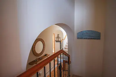a hallway with a stairway with a mirror and a mirror at NEW Villa 66 - Palheiro Village by YMR in São Gonçalo