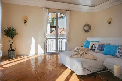 a living room with a couch and a window at NEW Villa 66 - Palheiro Village by YMR in São Gonçalo