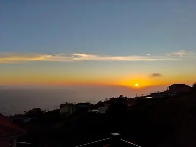 a sunset over the ocean with the sun in the sky at Golden Sun Refugio in Estreito da Calheta