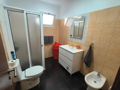 a bathroom with a toilet and a sink and a shower at Golden Sun Refugio in Estreito da Calheta