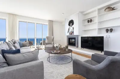 a living room with a couch and a fireplace at Villa Mar a Vista in Salema