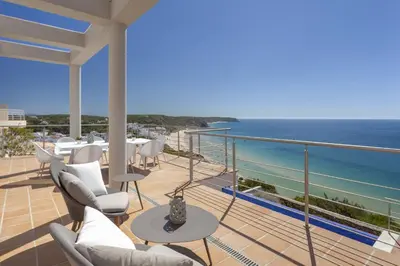 a balcony with chairs and a view of the ocean at Villa Mar a Vista in Salema