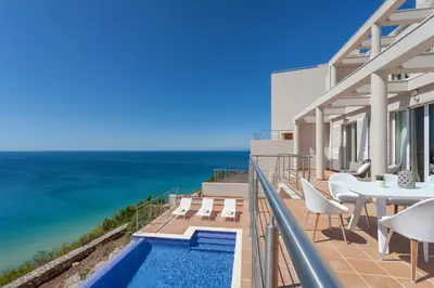 a view of the ocean from the balcony of a house at Villa Mar a Vista in Salema