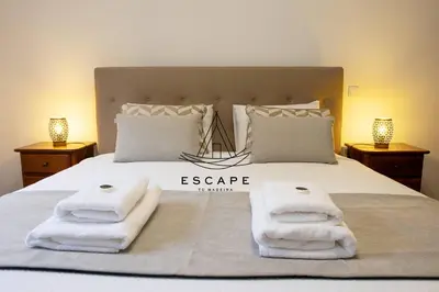 a bedroom with a bed with towels on it at Anavrin by Escape to Madeira in Ponta do Sol