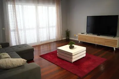 a living room with a couch and a tv at Atlantic Breeze - Free Parking in Funchal