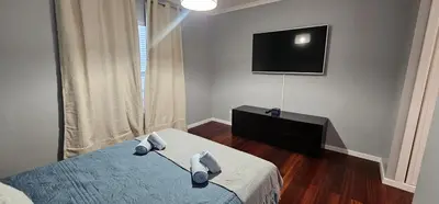 a bedroom with a bed and a flat screen tv at Atlantic Breeze - Free Parking in Funchal
