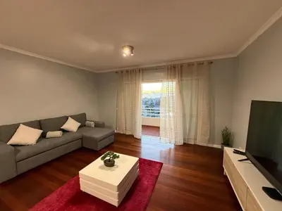 a living room with a couch and a television at Atlantic Breeze - Free Parking in Funchal