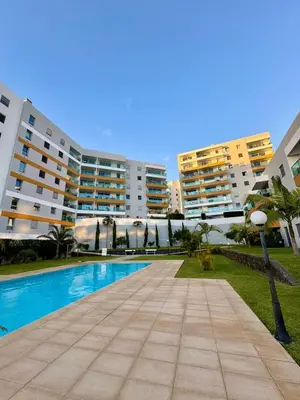 a swimming pool in front of some apartment buildings at Alameda Formosa Madeira in Funchal
