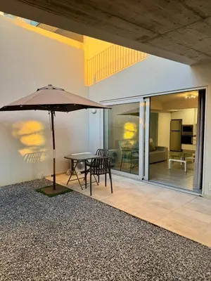 a patio with an umbrella and a table and chairs at Alameda Formosa Madeira in Funchal
