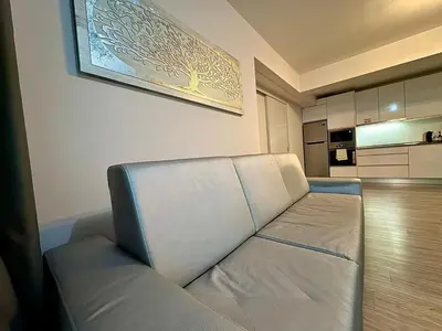 a couch sitting in a room with a kitchen at Alameda Formosa Madeira in Funchal