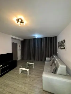 a living room with a couch and a television at Alameda Formosa Madeira in Funchal