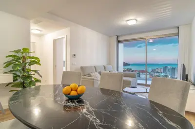 a living room with a couch and a large window at The Place Funchal View in Funchal