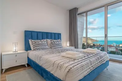 a bedroom with a large bed with a large window at The Place Funchal View in Funchal