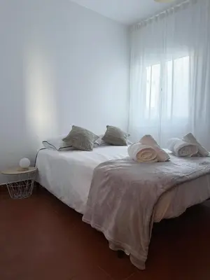 a couch with pillows on it with a window at Casa do Profeta in Porto Santo