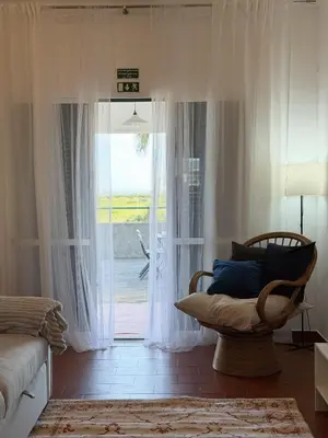 a living room with a tv and a couch at Casa do Profeta in Porto Santo