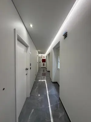a hallway of a hospital with white walls and a door at Gold Center Funchal 101 in Funchal