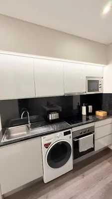a kitchen with a stove and a sink and a microwave at Gold Center Funchal 101 in Funchal