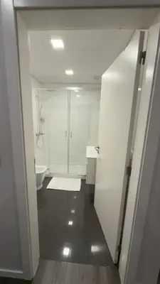 a white bathroom with a toilet and a sink at Gold Center Funchal 101 in Funchal