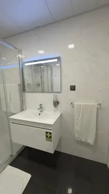 a white bathroom with a sink and a mirror at Gold Center Funchal 101 in Funchal