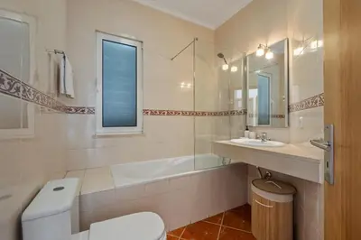 a bathroom with a tub and a toilet and a sink at Villa Lucente by Homie in Santa Maria Maior