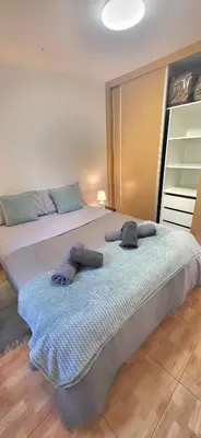 a large bed with two pillows on it in a room at Casa Vereda do Calhau - With barbecue in Campanário