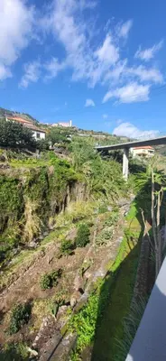 a view of a hill with a bridge and a river at Casa Vereda do Calhau - With barbecue in Campanário